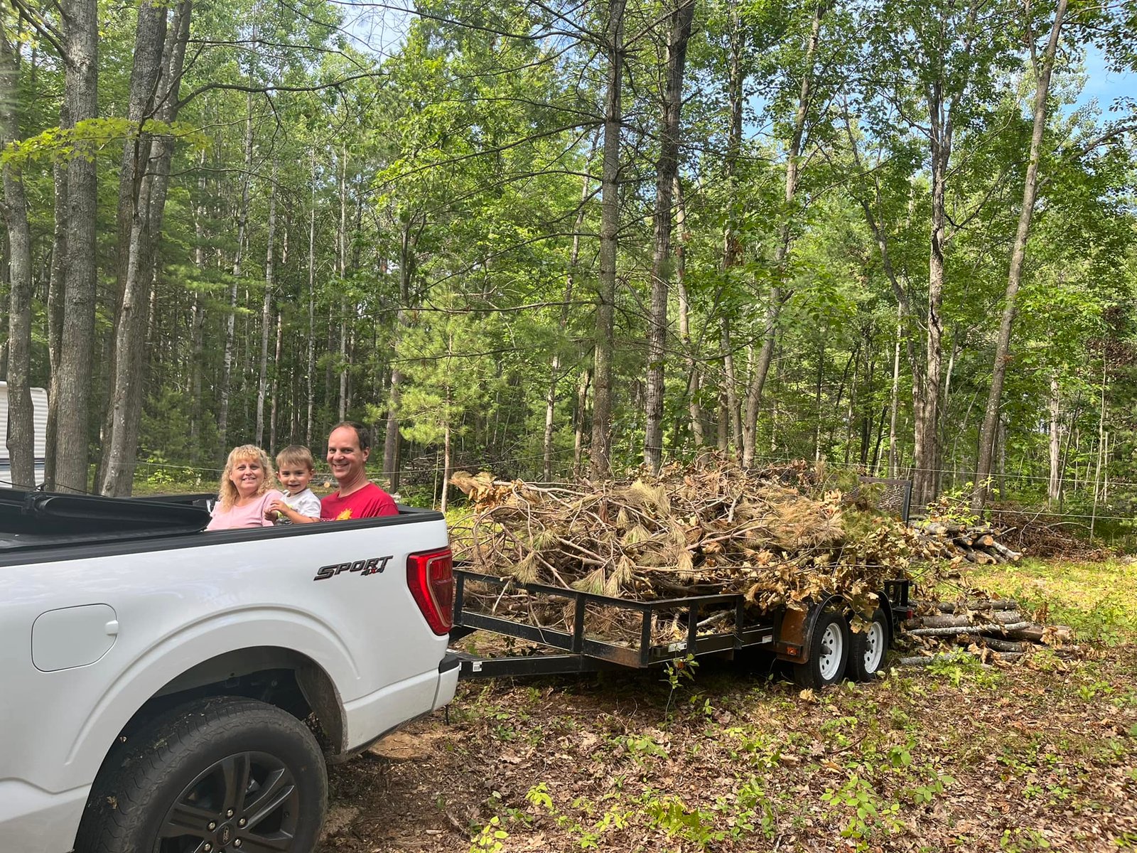 John, Sue and family clearing brush from the campground